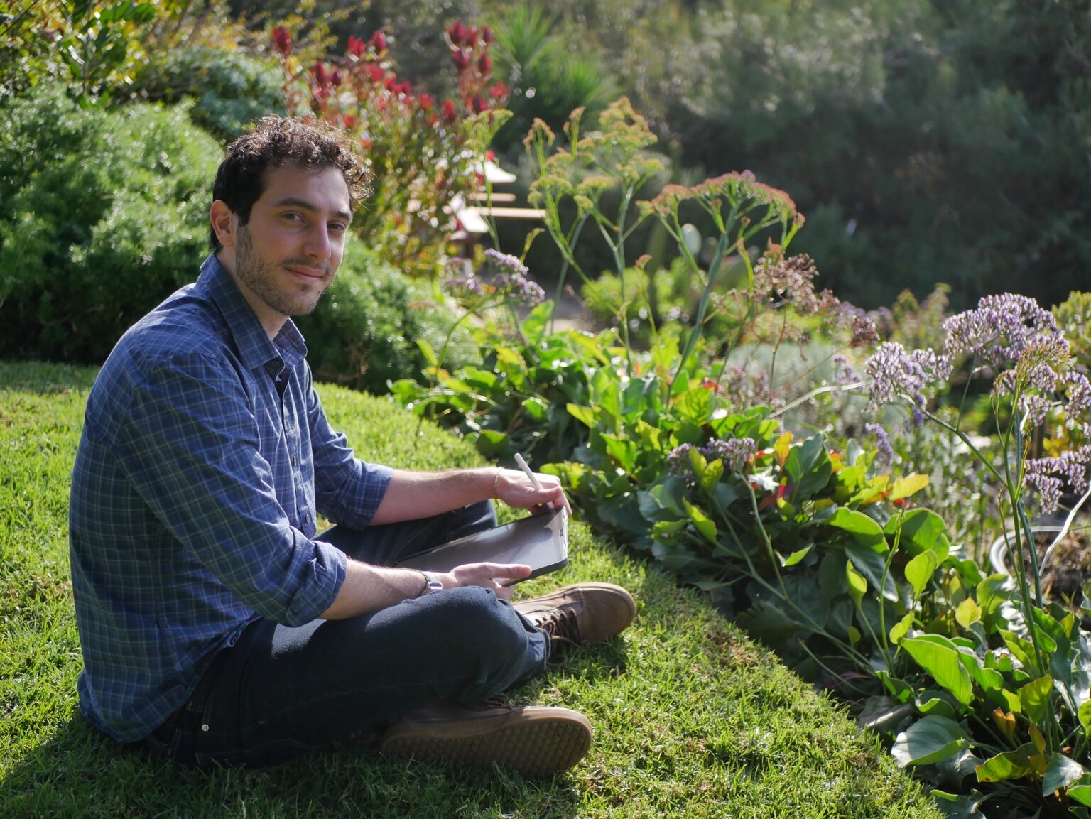 Itamar Patek writing outdoors
